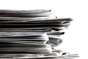 Stack of newspapers - service journalism